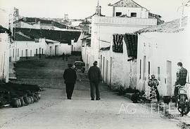 Dos hombres caminan por las calles de un pueblo